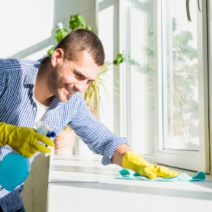 team member cleaning window sill